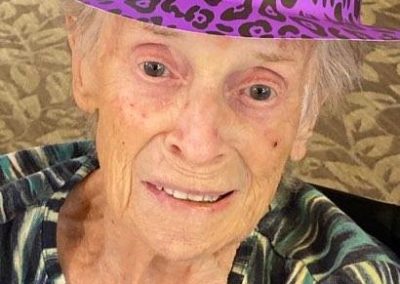 portrait of elderly woman in cheetah print hat