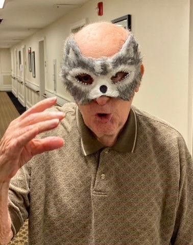 portrait of elderly man wearing a wolf mask