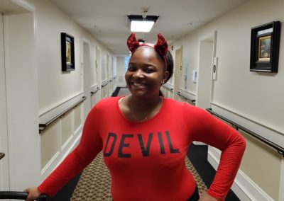 woman poses in devil shirt and horns