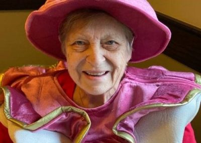 elderly woman dressed as Mrs. Pots